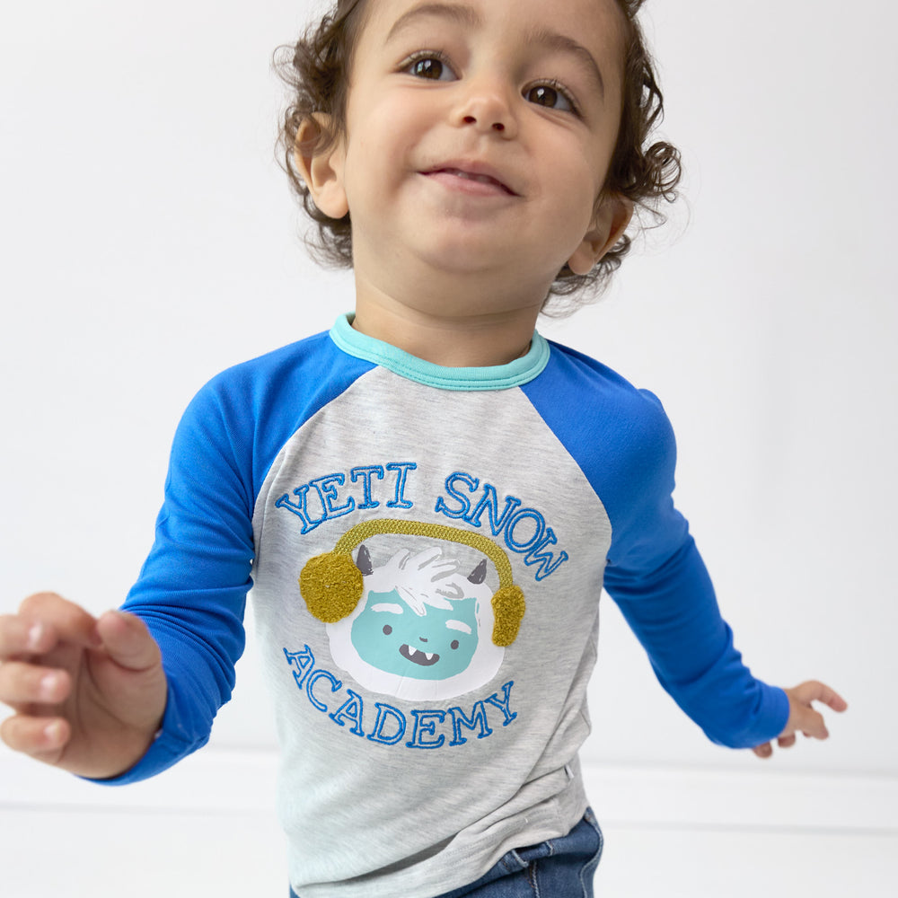 Close up image of boy wearing the Yeti Snow Academy Raglan Tee