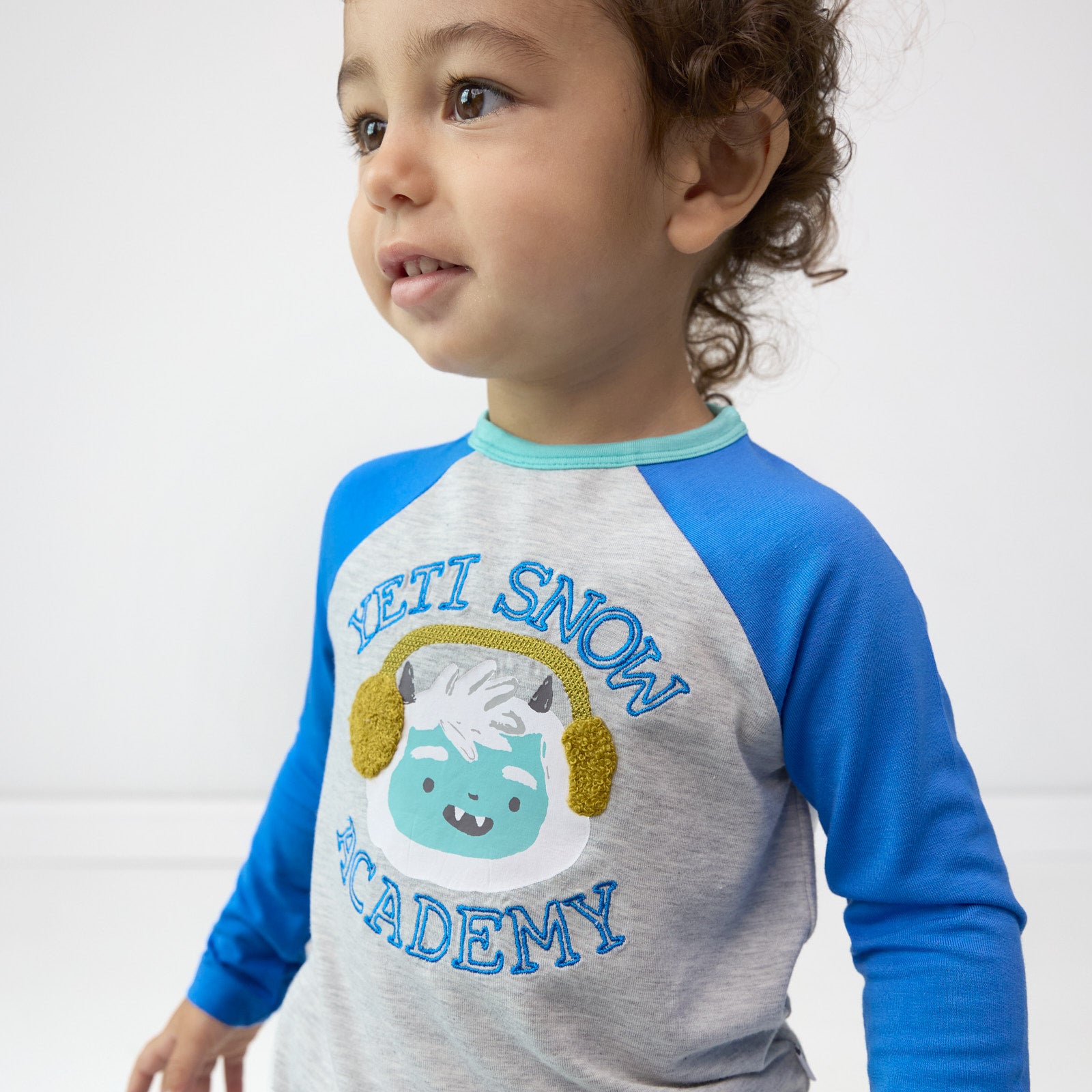 Alternative close up image of boy wearing the Yeti Snow Academy Raglan Tee