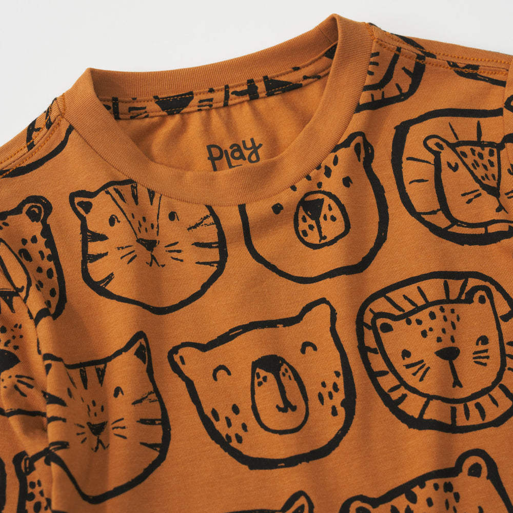 Close-up view of the neckline of an Amber Lions, Tigers & Bears relaxed tee with black animal illustrations