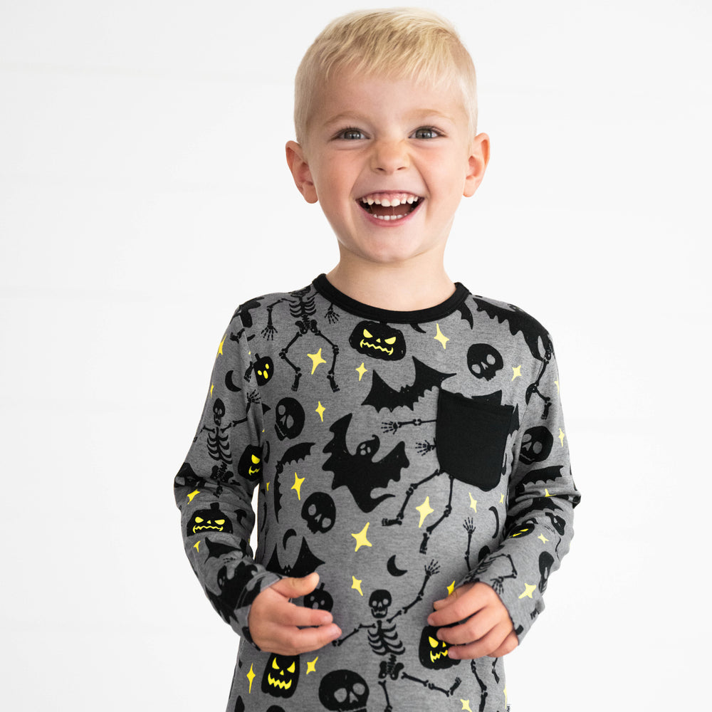 Boy smiling while wearing the Gray Glowing Ghouls Pocket Tee