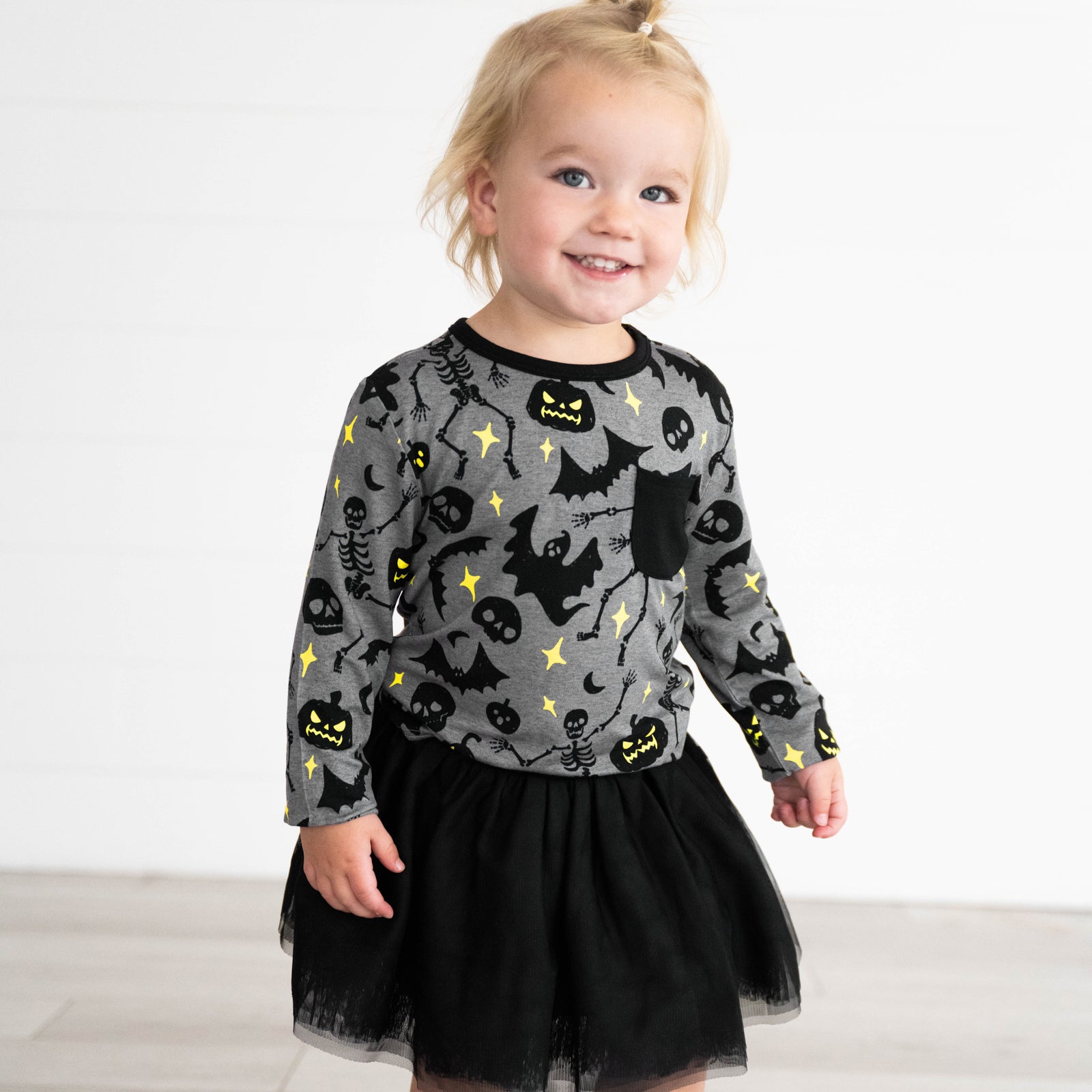 Girl wearing the Gray Glowing Ghouls Pocket Tee and Black Tutu Skirt