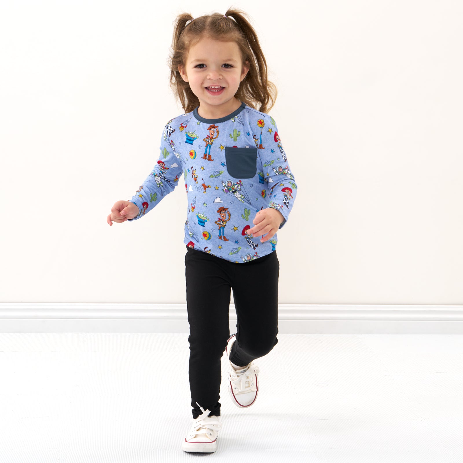 Child wearing a Disney Pixar Toy Story Pals pocket tee and coordinating leggings
