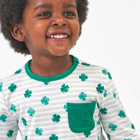 Close up image of a child wearing a Lucky Stripes pocket tee