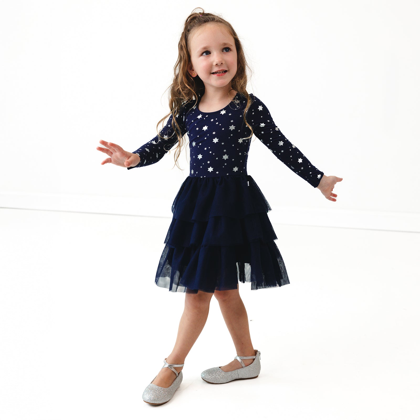 Child posing wearing a Hanukkah Stars Tiered Tutu Dress