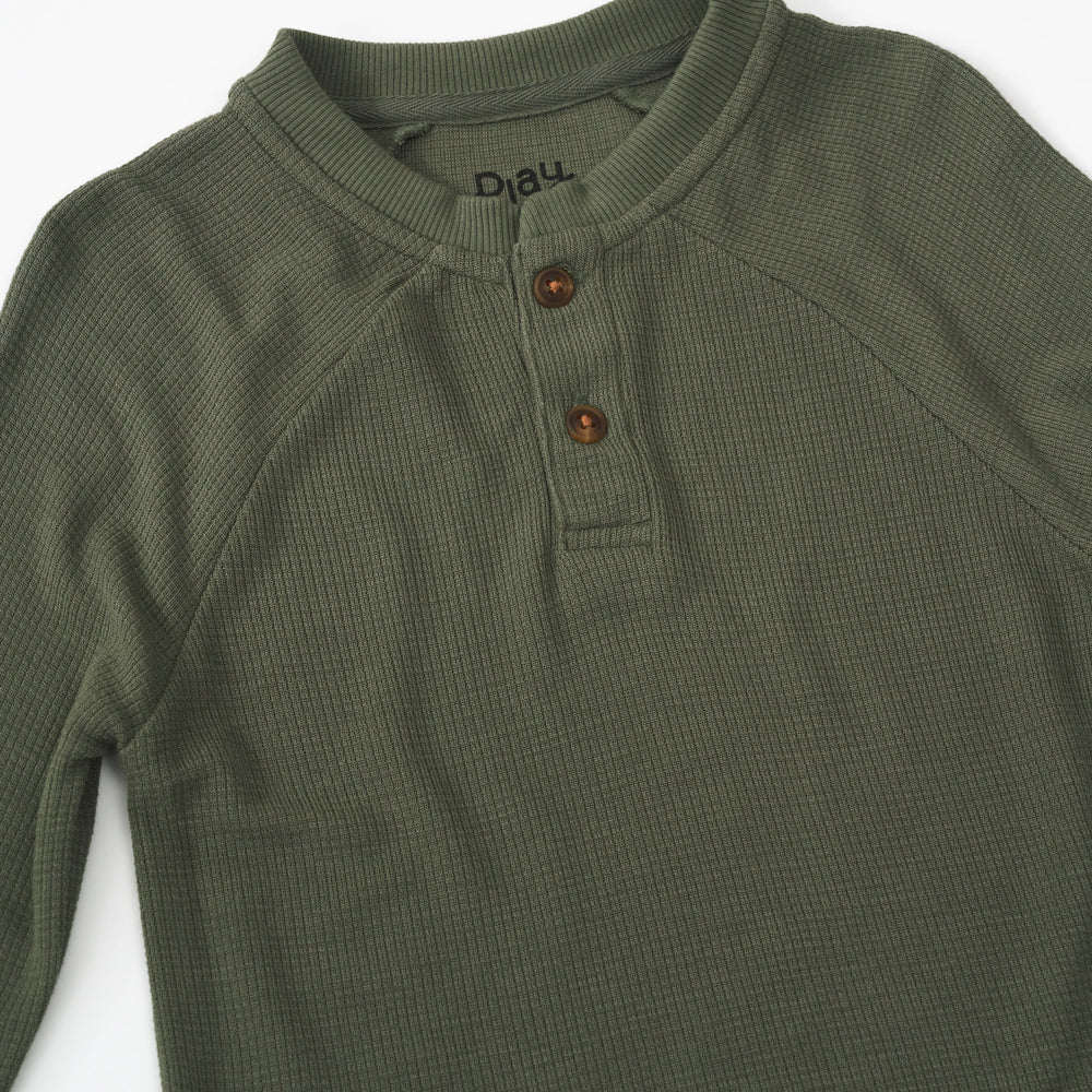 Close up detail shot of an Olive Waffle Henley Tee