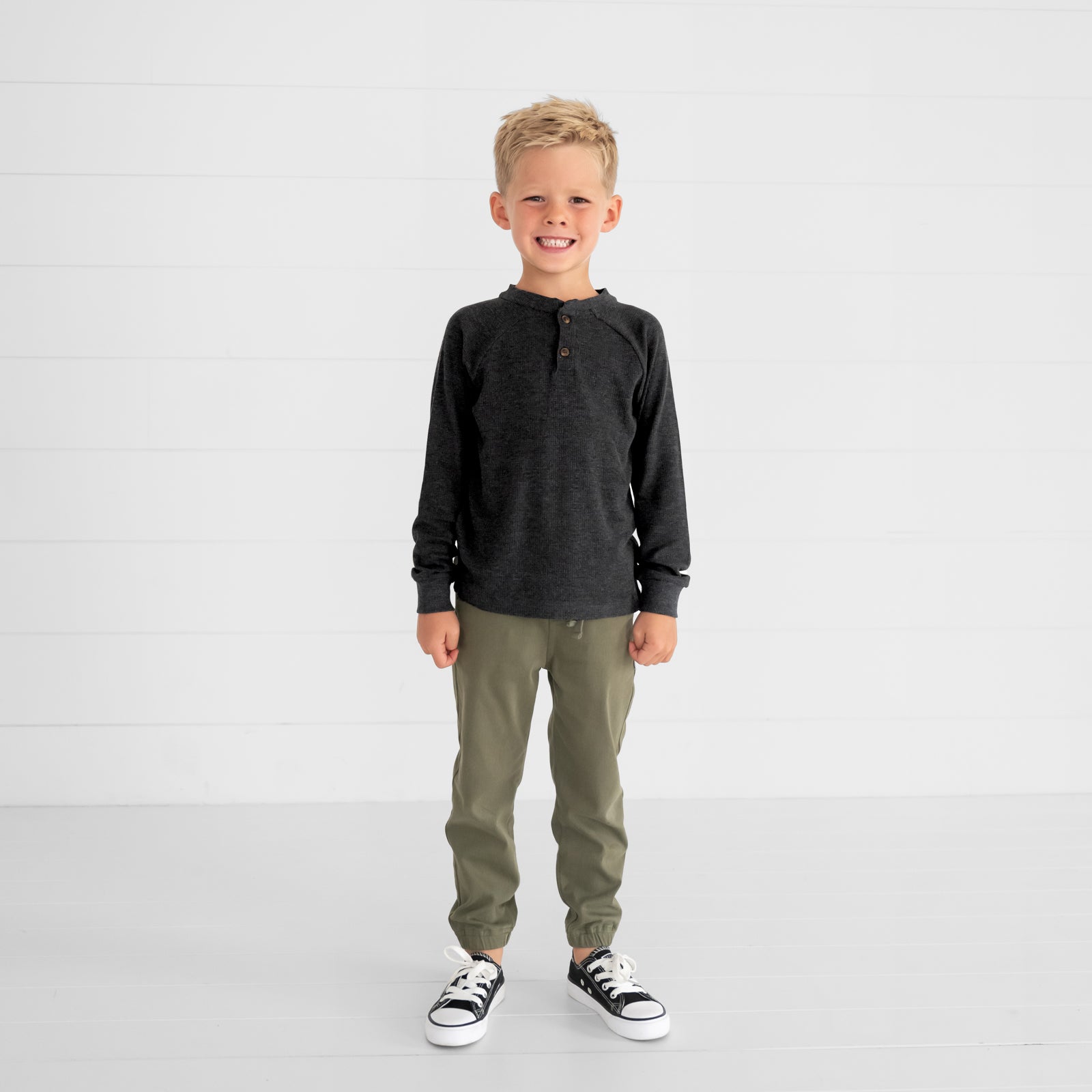 Image of a child wearing a Heather Black Waffle Henley Tee and Olive Denim Jogger