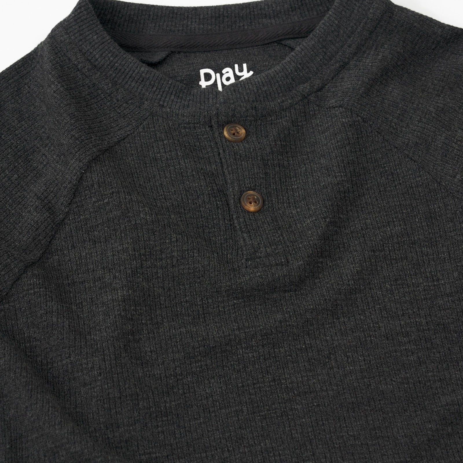 Close up detail shot of a Heather Black Waffle Henley Tee