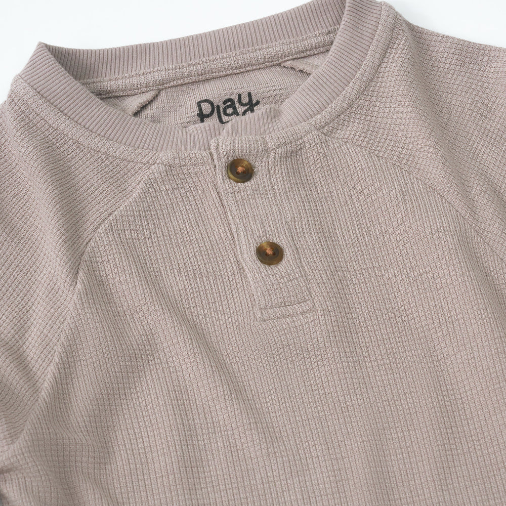 Close up detail shot of a Pebble Waffle Henley Tee