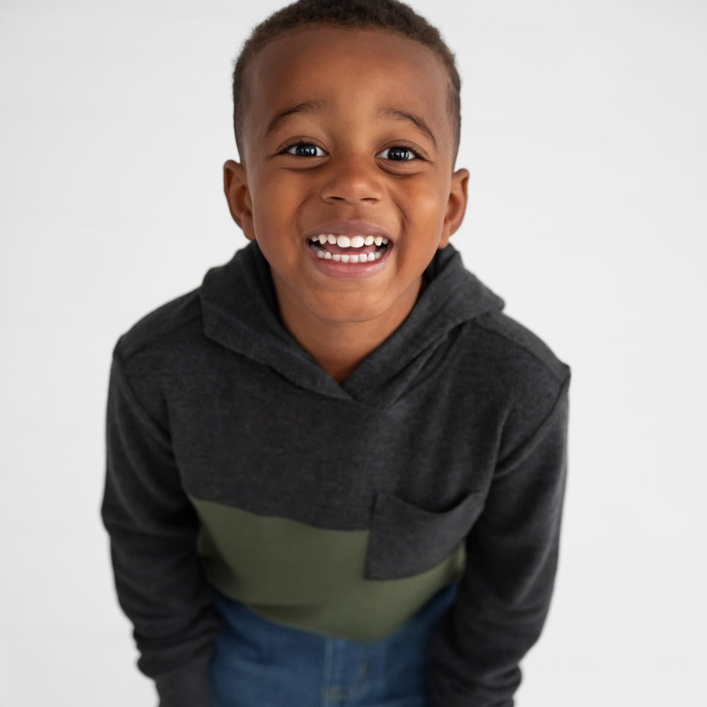 Alternate close up image of a child wearing a Heather Black Waffle Hooded Tee and Midwash Blue Denim Jogger