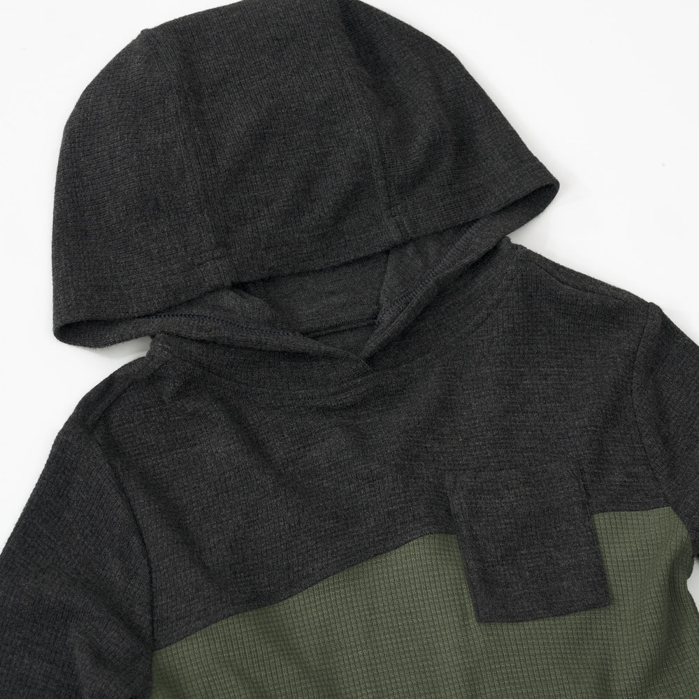 Close up detail shot of a Heather Black Waffle Hooded Tee