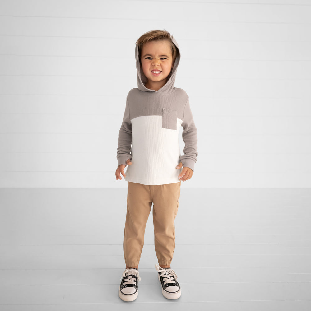 Image of a child wearing a Pebble Waffle Hooded Tee and Toasted Hazelnut Denim Jogger