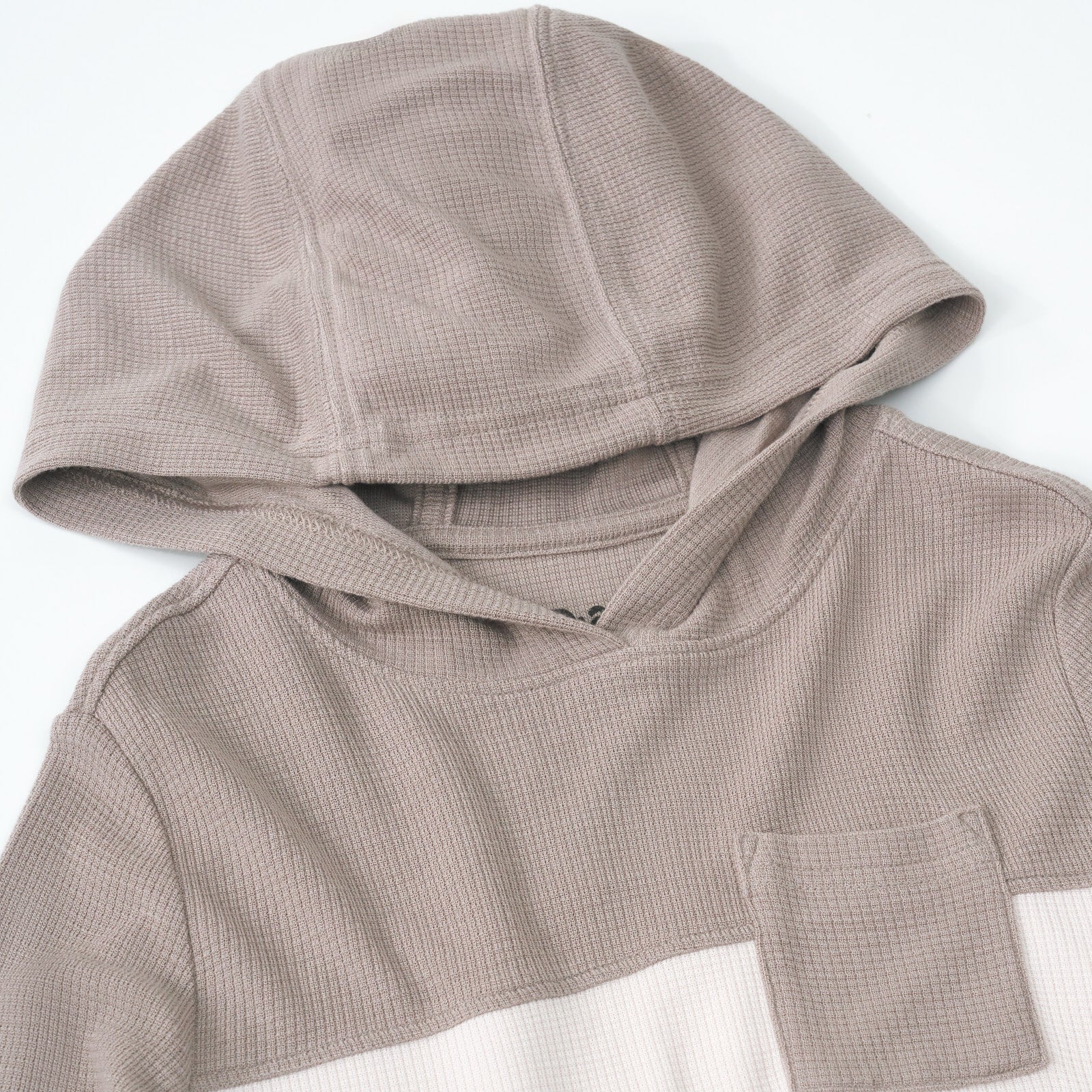 Close up detail shot of a Pebble Waffle Hooded Tee