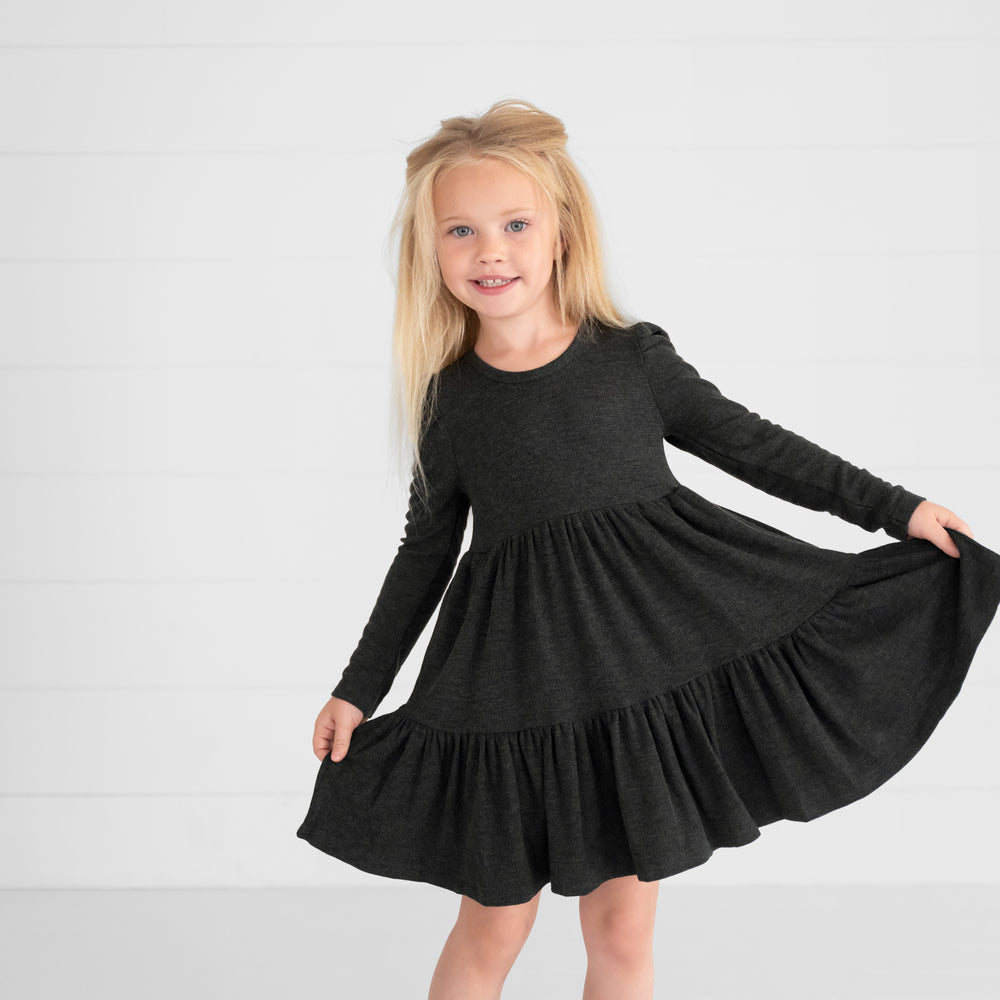 Image of a child wearing a Heather Black Waffle Tiered Dress