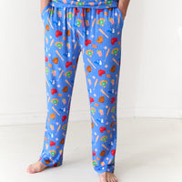 Close up image of a man with his hands in his pockets wearing Blue All Stars men's pajama pants