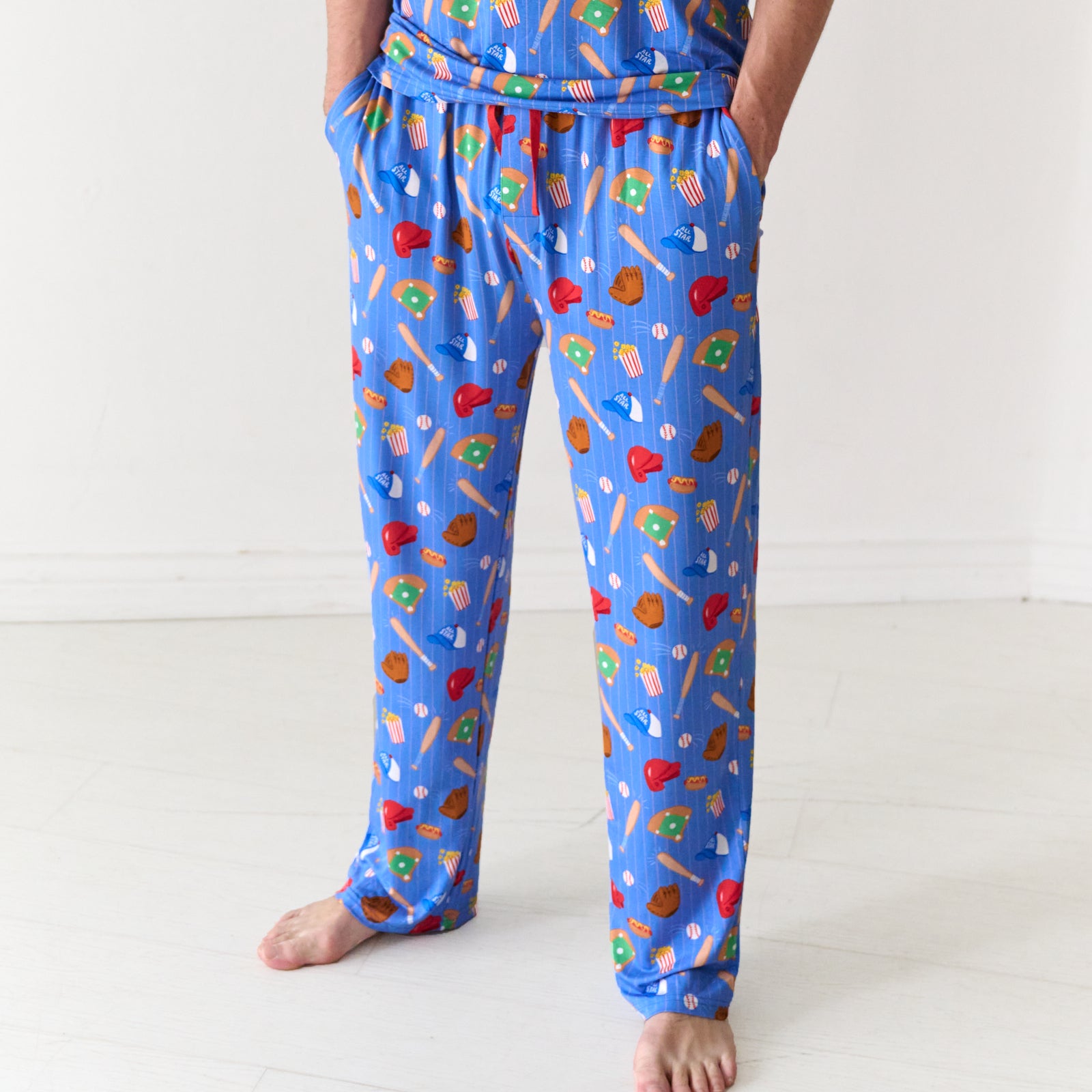 Alternate close up image of a man with his hands in his pockets wearing Blue All Stars men's pajama pants