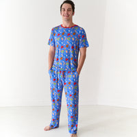 Man with his hands in his pockets wearing Blue All Stars men's pajama pants and matching men's pajama top