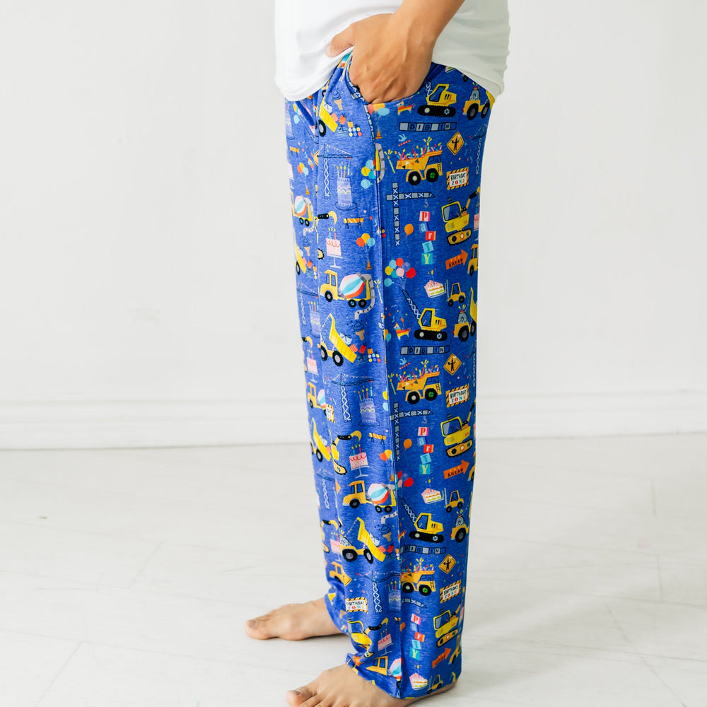 Close Up Side Image Of Man Wearing Birthday Builder Pajama Pants