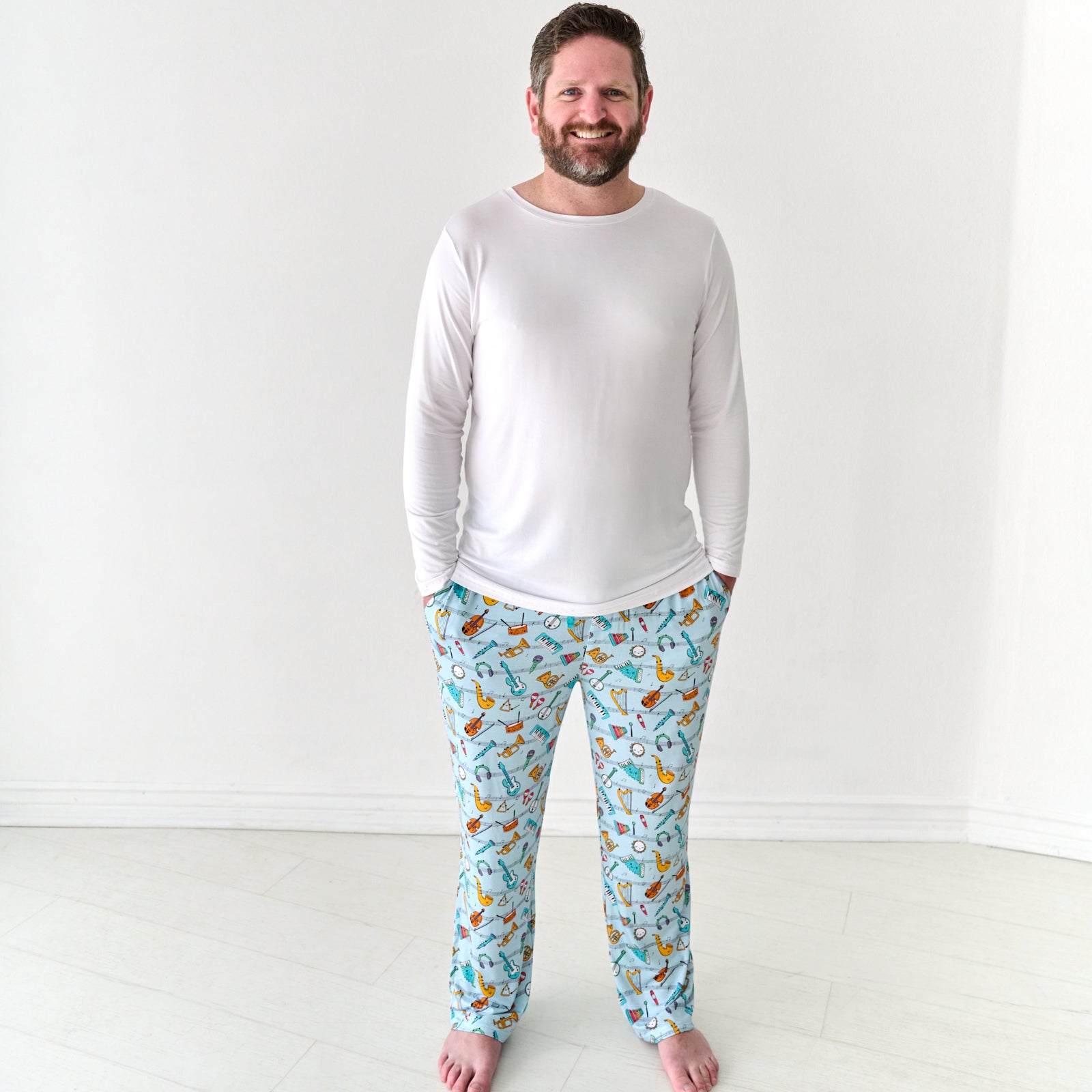 Man wearing Play Along men's pajama pants and coordinating pajama top