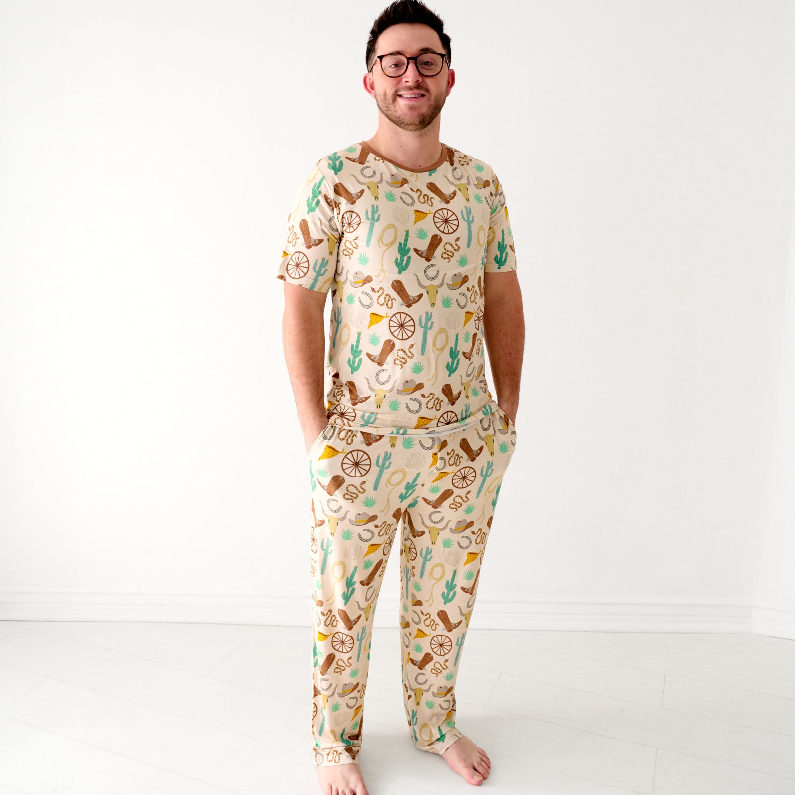 Image of a man wearing Caramel Ready to Rodeo men's pajama pants paired with a matching men's pajama top