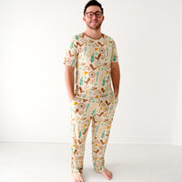 Image of a man wearing Caramel Ready to Rodeo men's pajama pants paired with a matching men's pajama top