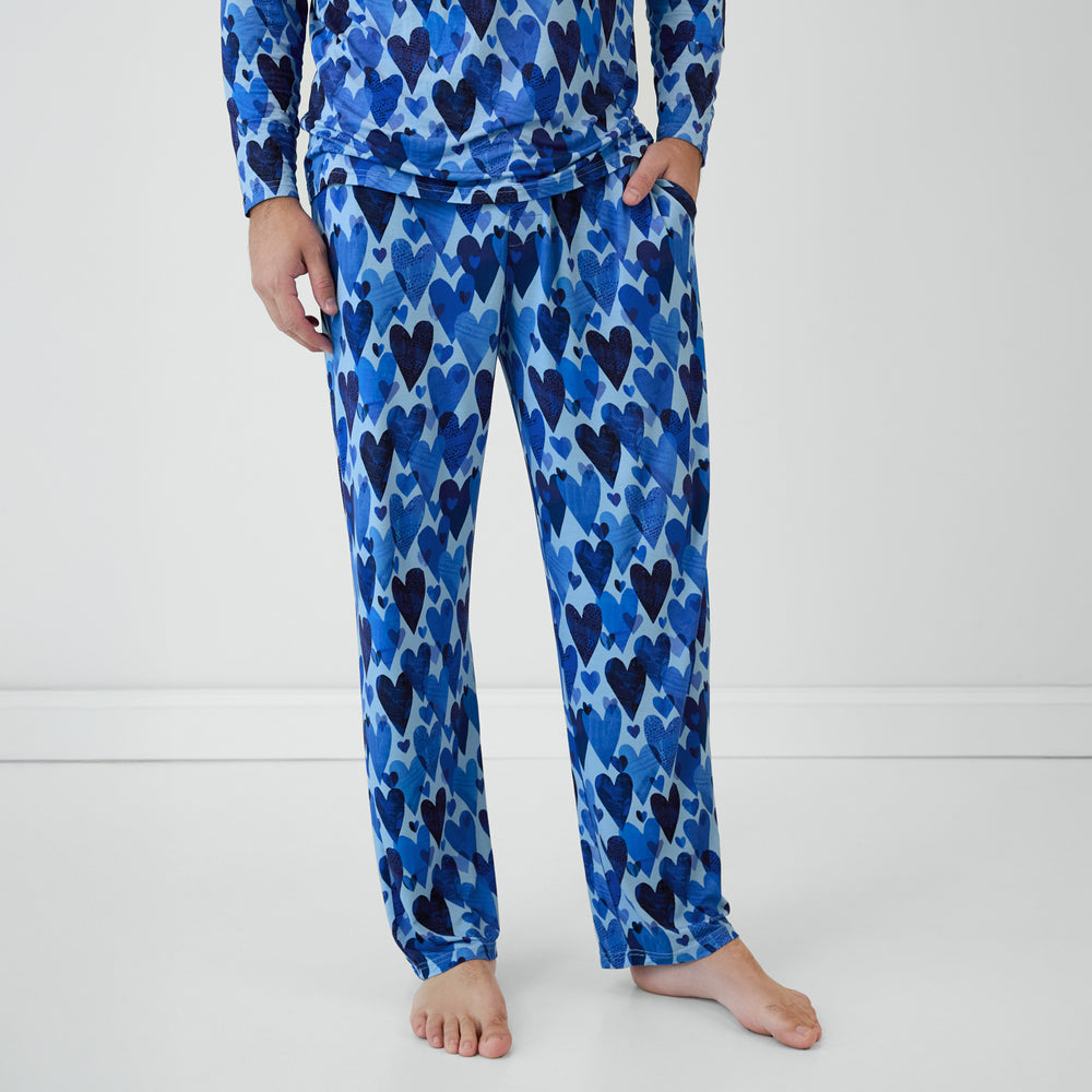 Cropped view of man in Blue Hearts & Crafts pajama pants.