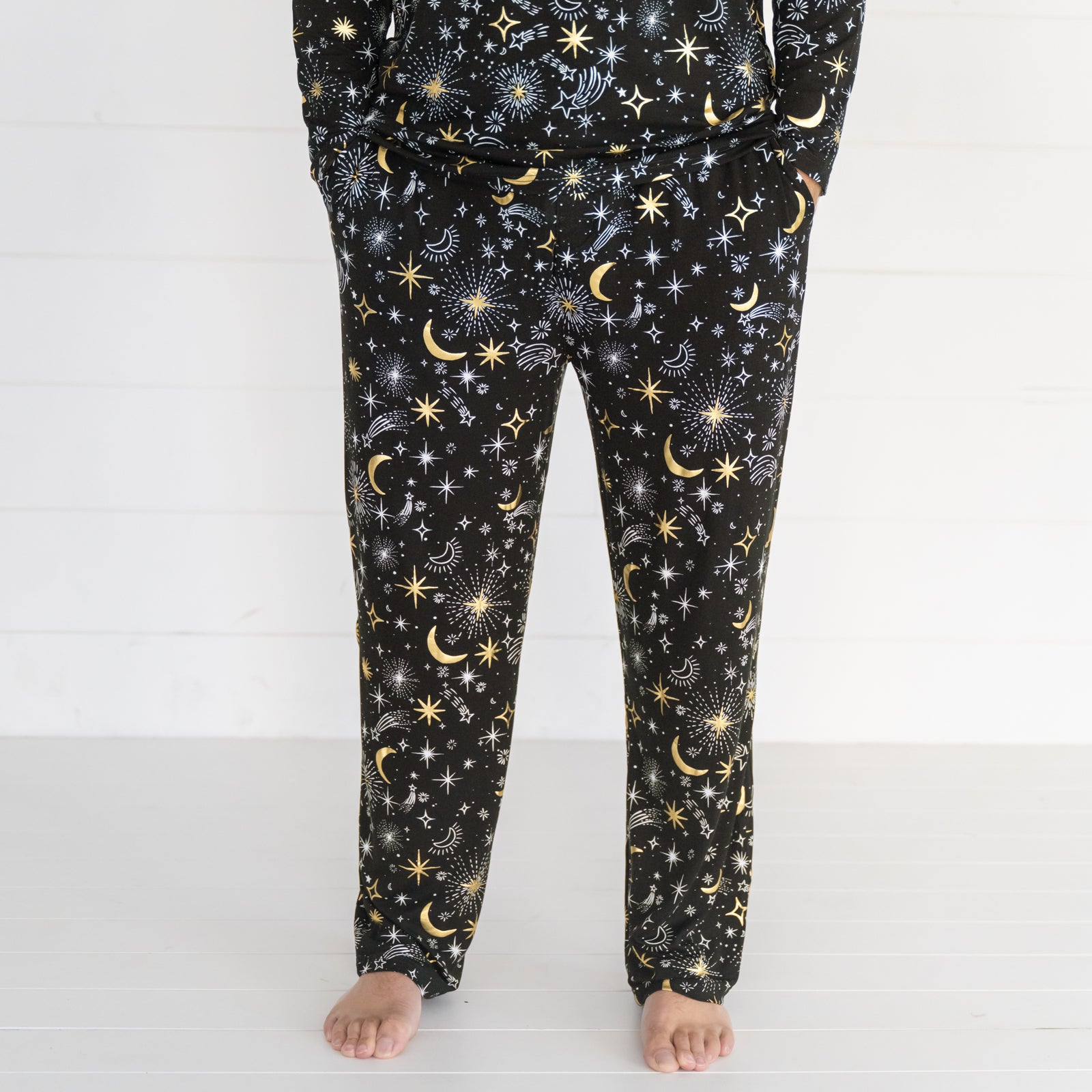 Close up image of a man wearing Celebration Stars pj pants