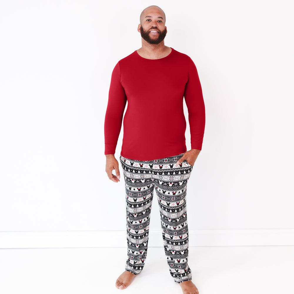 Image of a man wearing Mickey Fair Isle men's pj pants and coordinating Holiday Red pj top