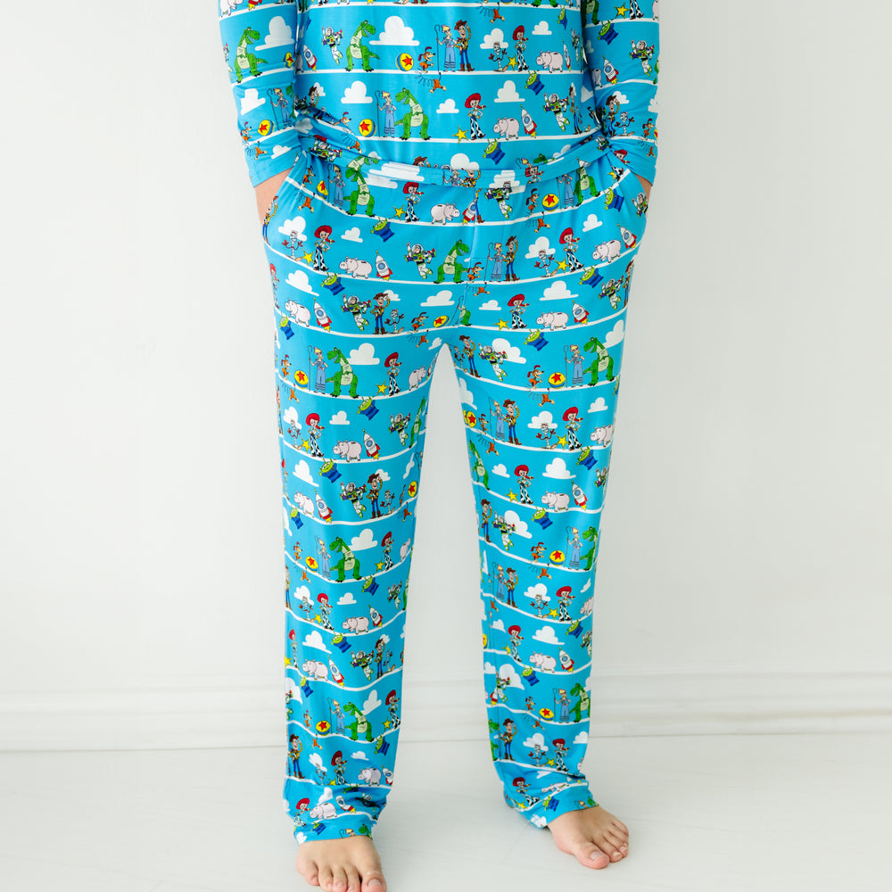 Click to see full screen - Close up image of a man wearing Disney Pixar Toy Story Pals men's pajama pants and matching pajama top