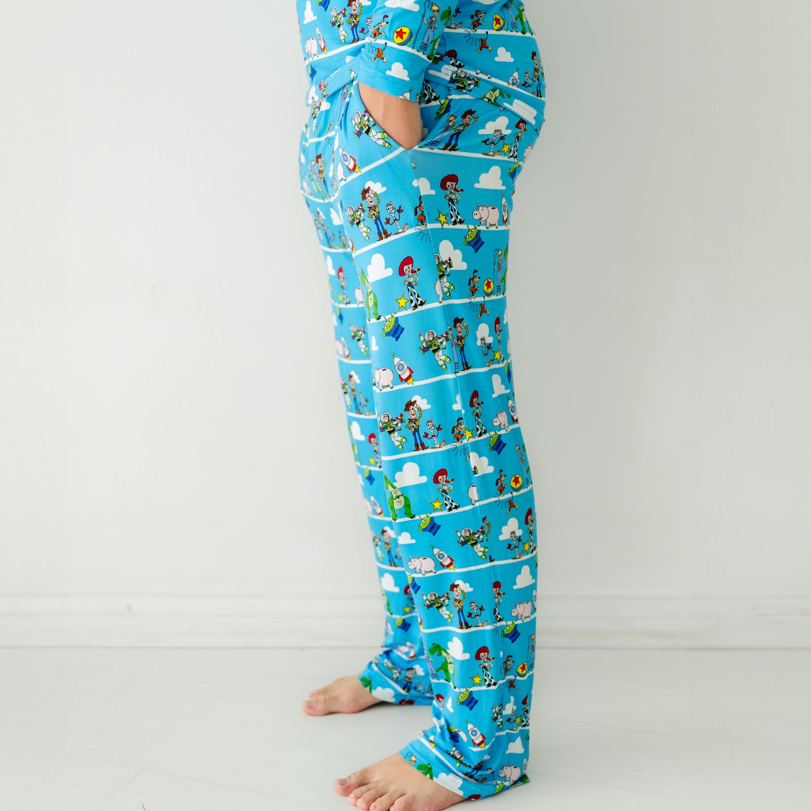 Side view image of a man wearing Disney Pixar Toy Story Pals men's pajama pants and matching pajama top