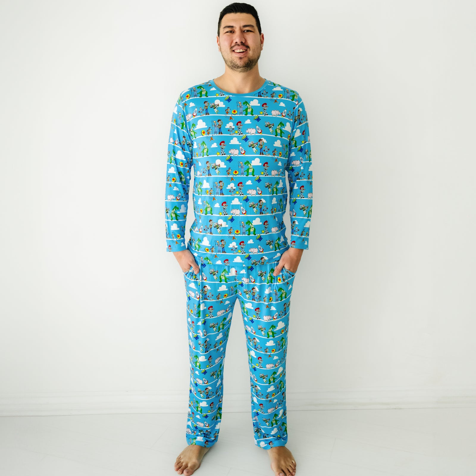 Man wearing a Disney Pixar Toy Story Pals men's pajama pants and matching pajama top