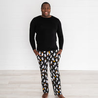 Man wearing the Friendly Ghosts Men's Pajama Pants with hands in pockets