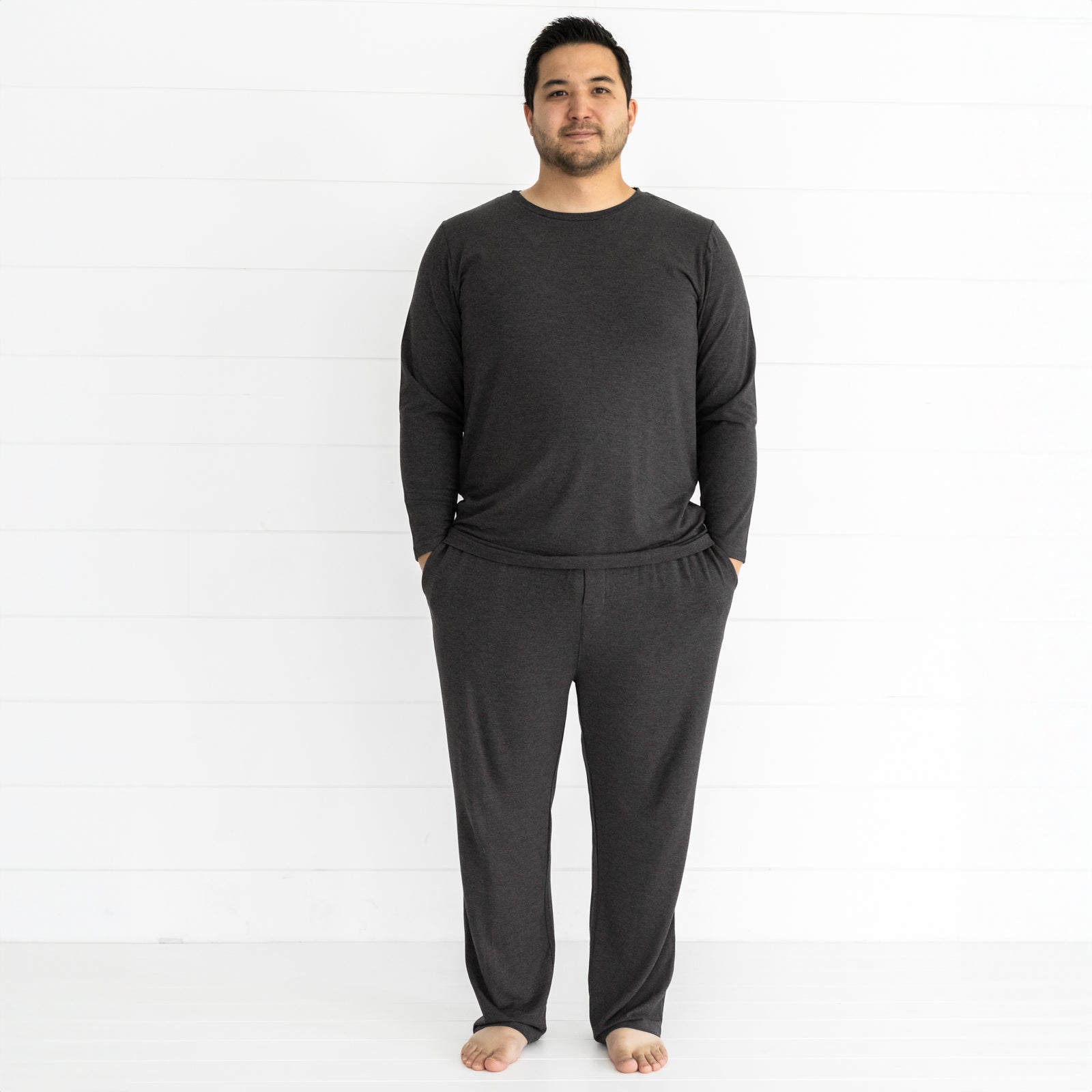 man wearing men's cozy heather black pj top and matching pants