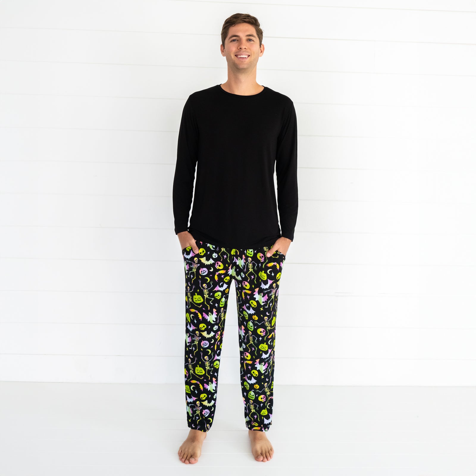 Man wearing a Cool Ghouls men's pj pants and men's black top