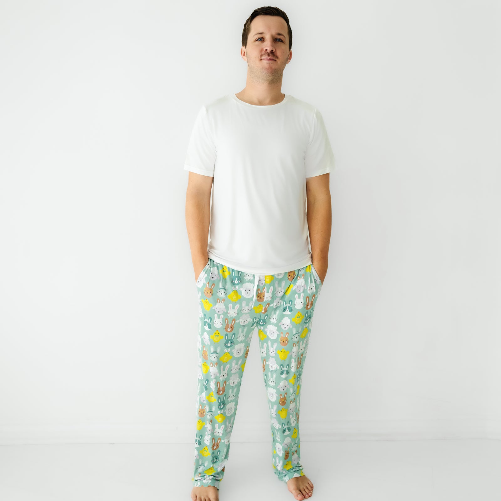 Image of a man wearing Aqua Pastel Parade men's pajama pants paired with a Bright White men's short sleeve pajama top