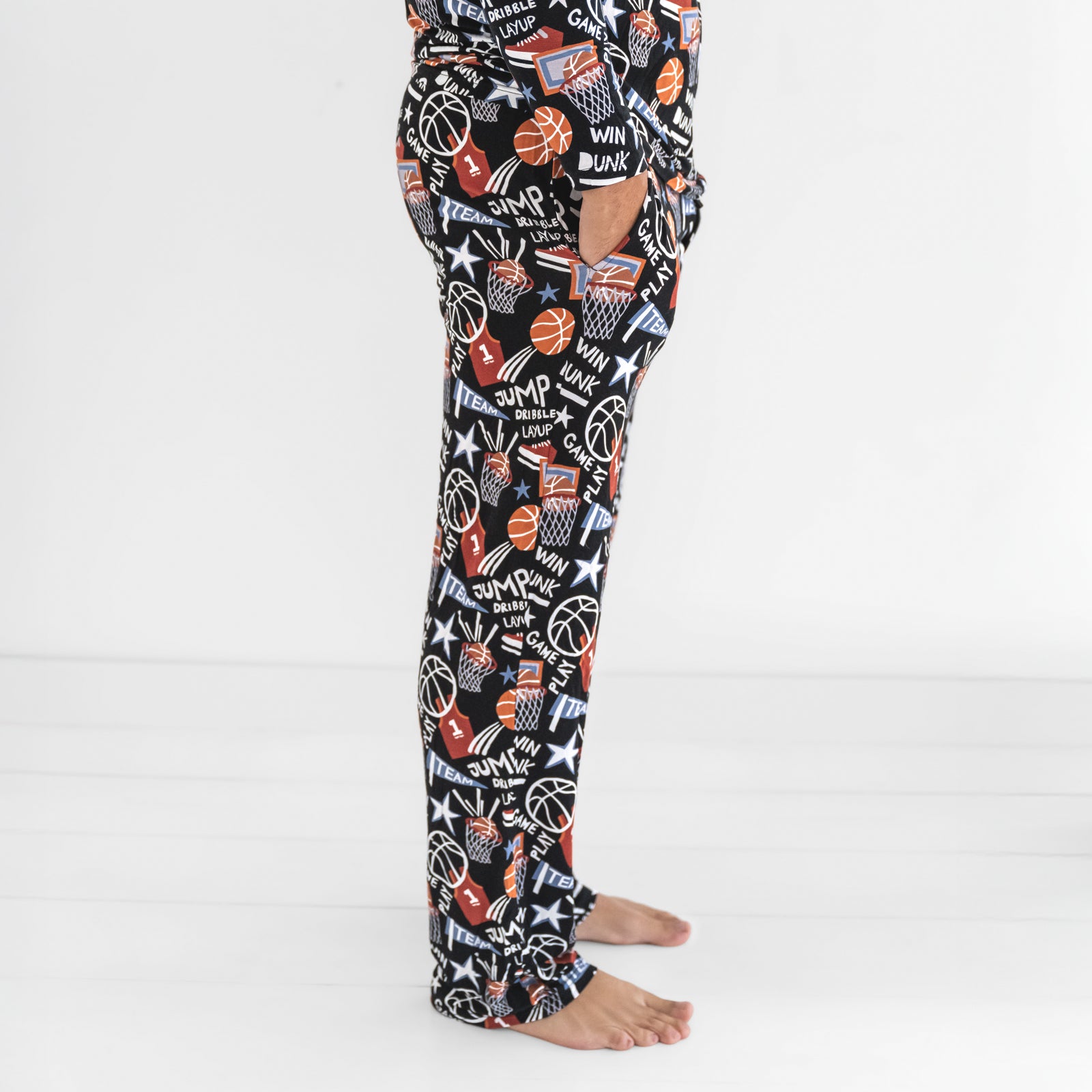 Side view of a man wearing the Black Slam Dunk mens bamboo pajama pants