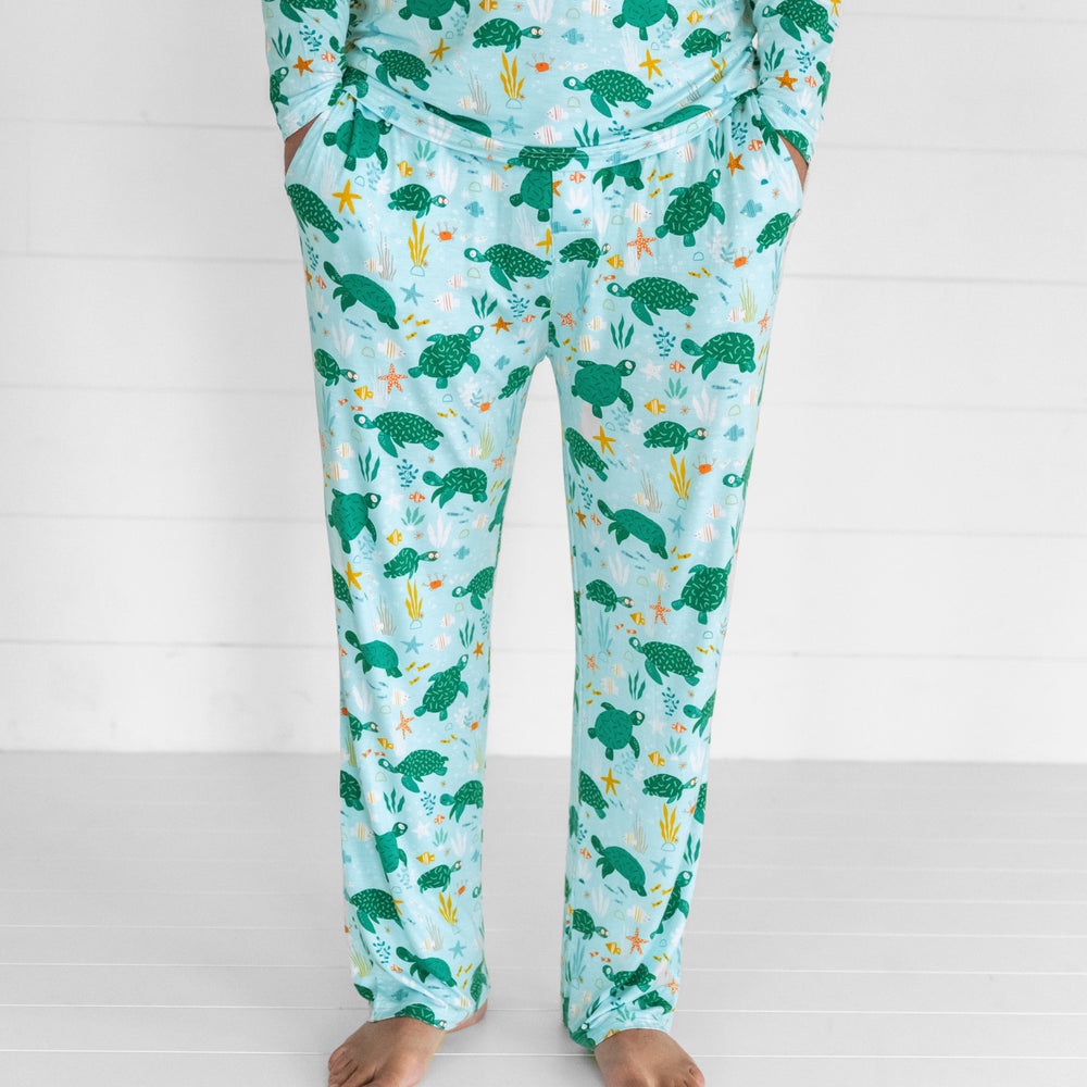 Close up image of a man wearing Sea Turtle Friends men's pj pants