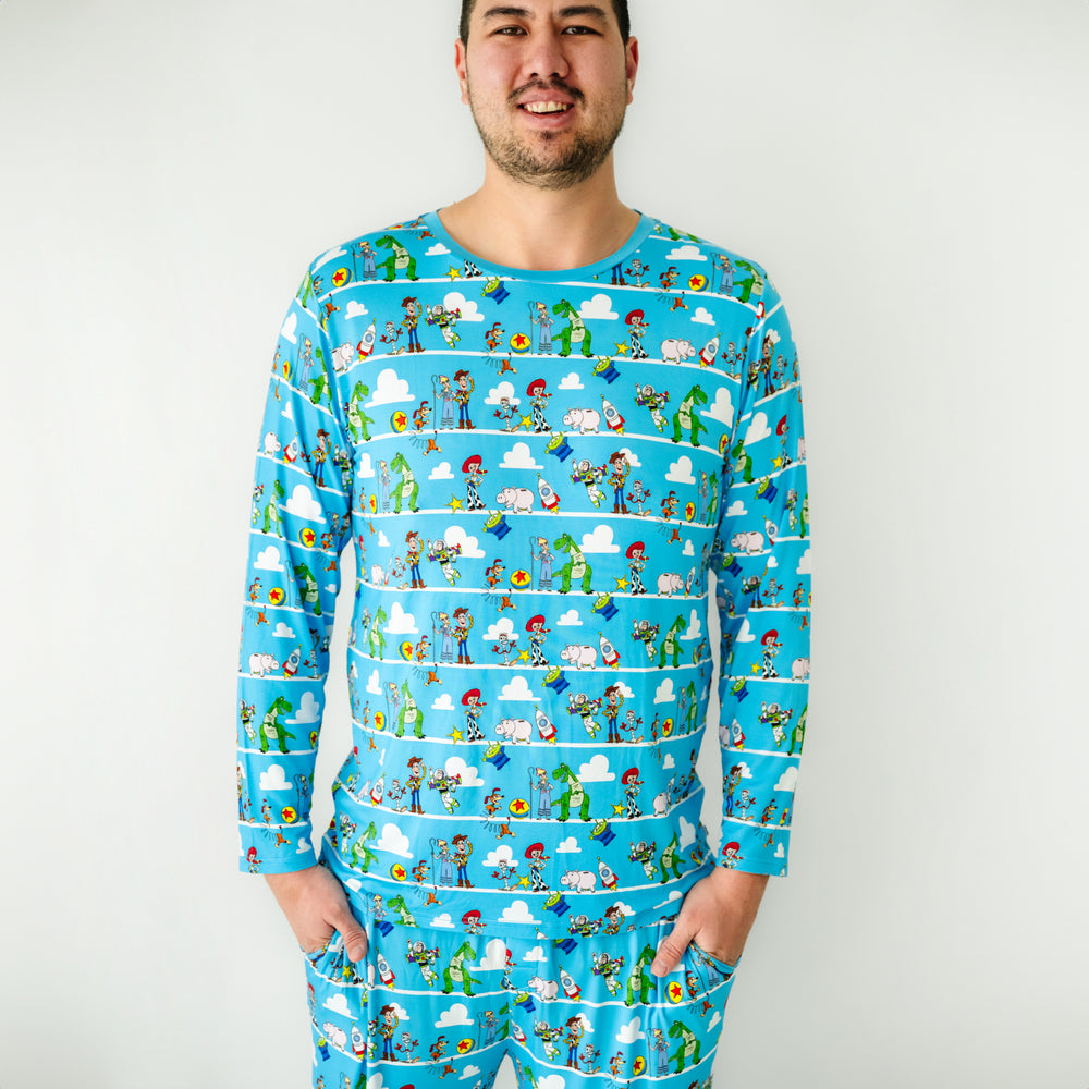 Click to see full screen - Close up image of a man wearing a Disney Pixar Toy Story Pals men's pajama top and matching pajama pants