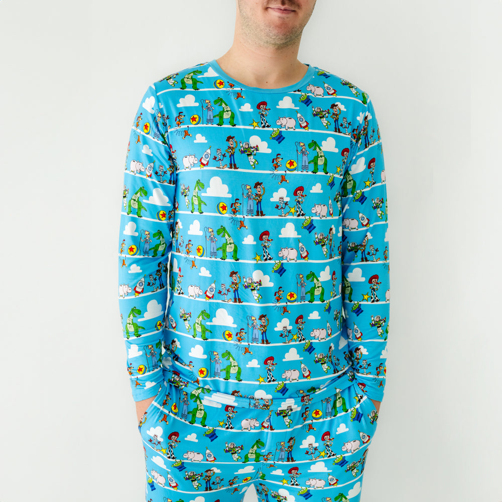 Click to see full screen - Alternate close up image of a man wearing a Disney Pixar Toy Story Pals men's pajama top and matching pajama pants