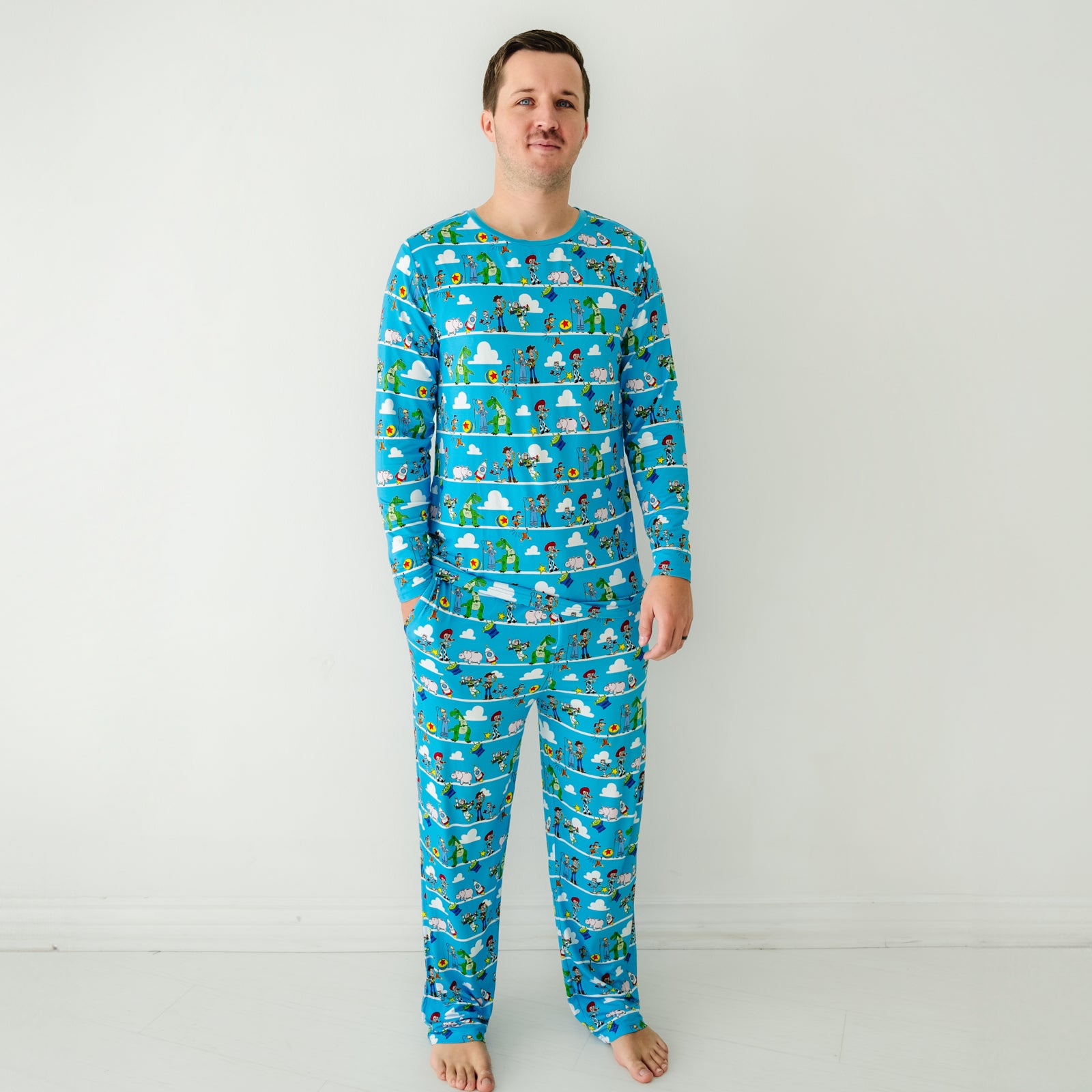 Man wearing a Disney Pixar Toy Story Pals men's pajama top and matching pajama pants