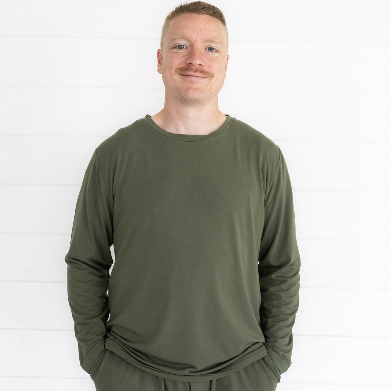 Close up image of a man wearing a Cozy Olive men's pj top