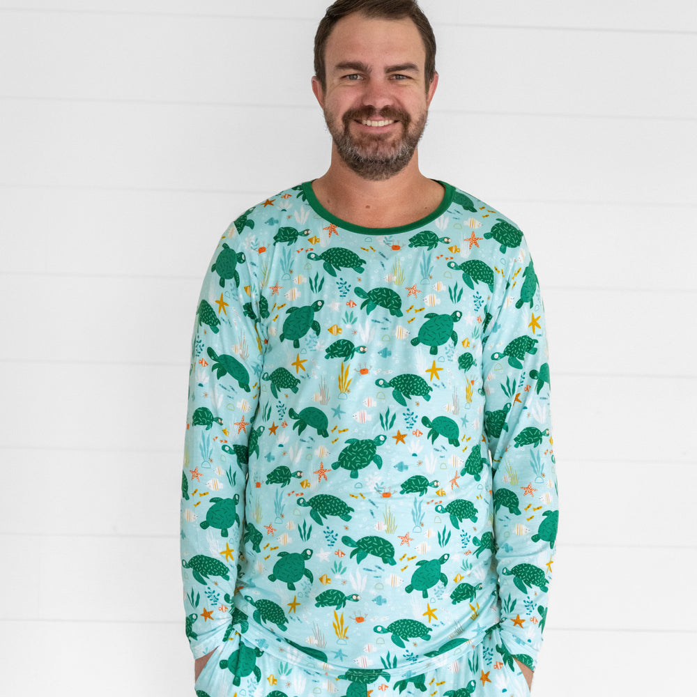 Close up image of a man wearing a Sea Turtle Friends men's pj top