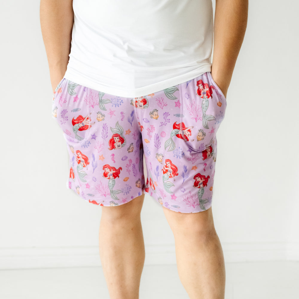 Close up image of a man wearing Disney Part of Her World men's pajama shorts