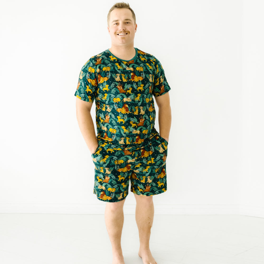Image of a man wearing Disney Simba's Sky men's pajama shorts paired with a matching men's pajama shirt