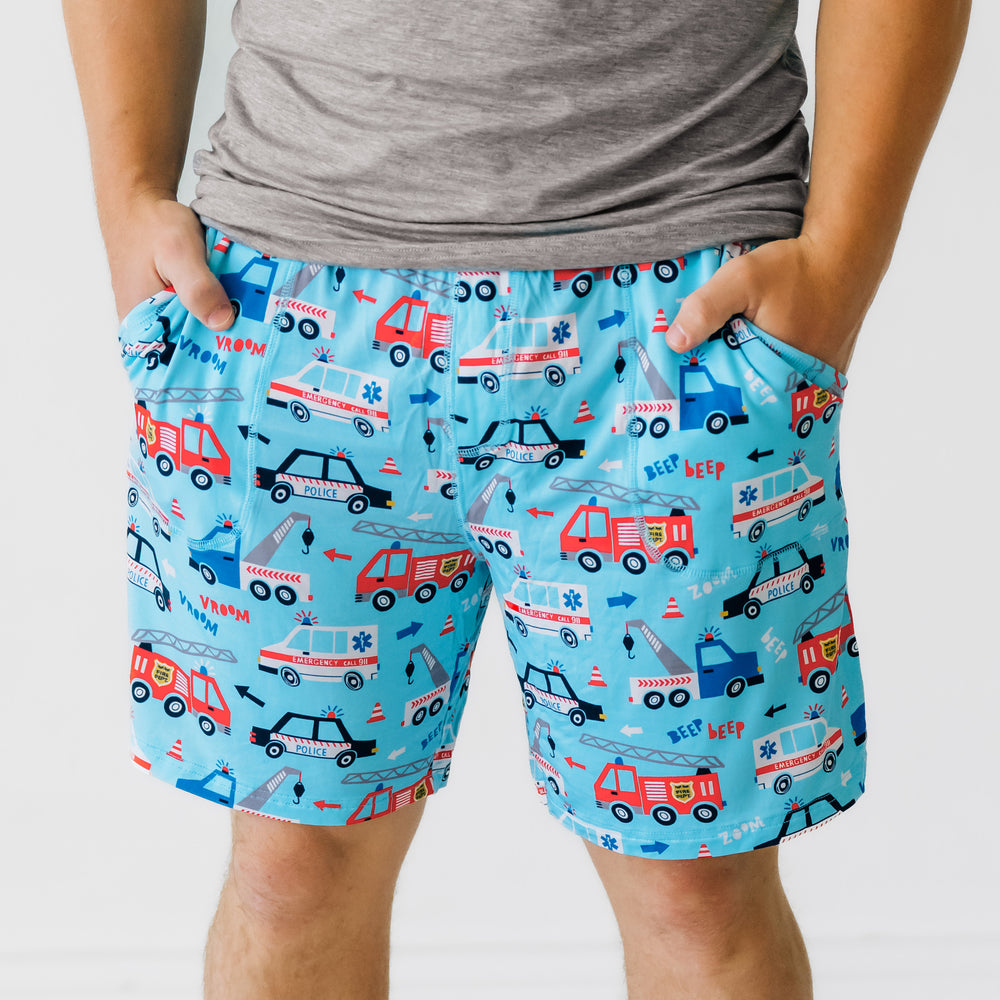 Close up image of a man wearing a men's To the Rescue pj shorts