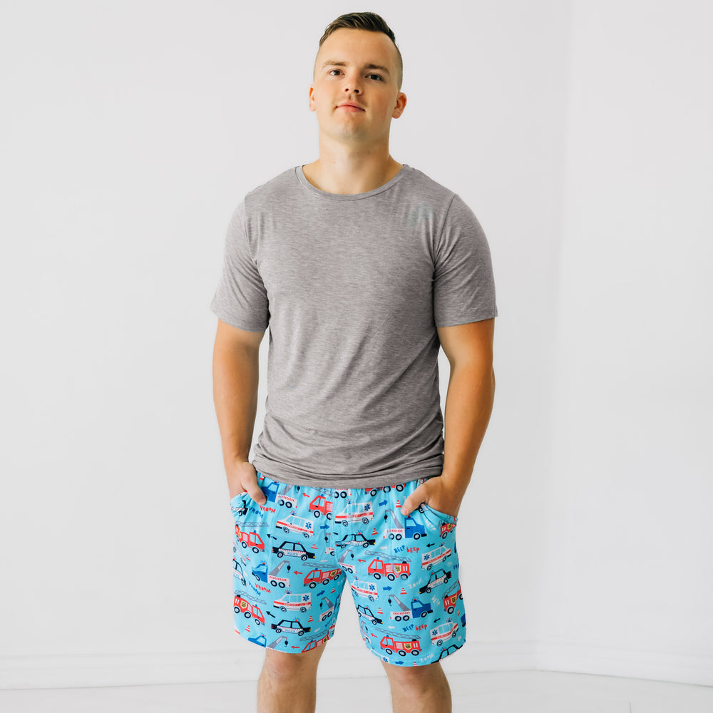 Man wearing a men's To the Rescue pj shorts and coordinating heather gray men's pajama top.