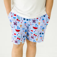 Close up image of a man wearing Stars Stripes and Sweets printed men's pj shorts
