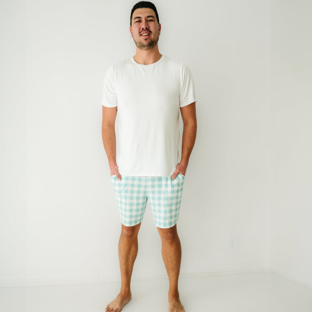Click to see full screen - Man wearing Aqua Gingham men's pajama shorts paired with a men's Bright White short sleeve pajama top