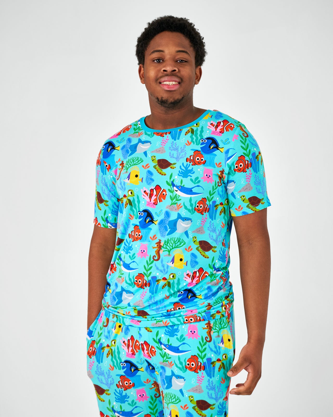 Standing man wearing the Disney Nemo's Reef Men's Short Sleeve Pajama Top