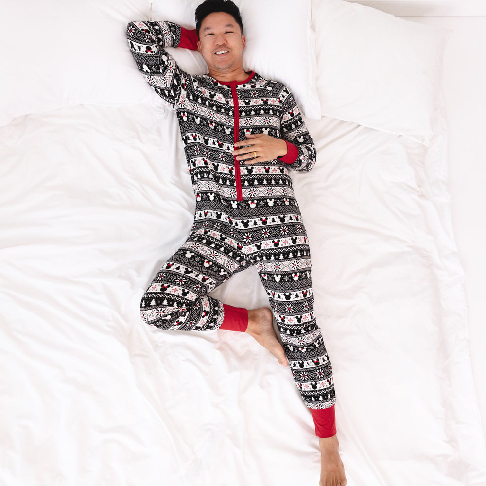 Man laying on a bed wearing a men's Mickey Fair Isle adult zippy