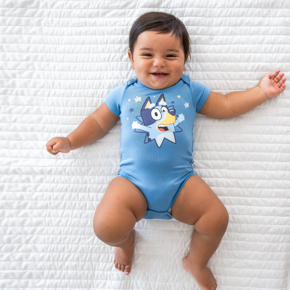 Top view image of baby laying down in the Bluey Graphic Bodysuit